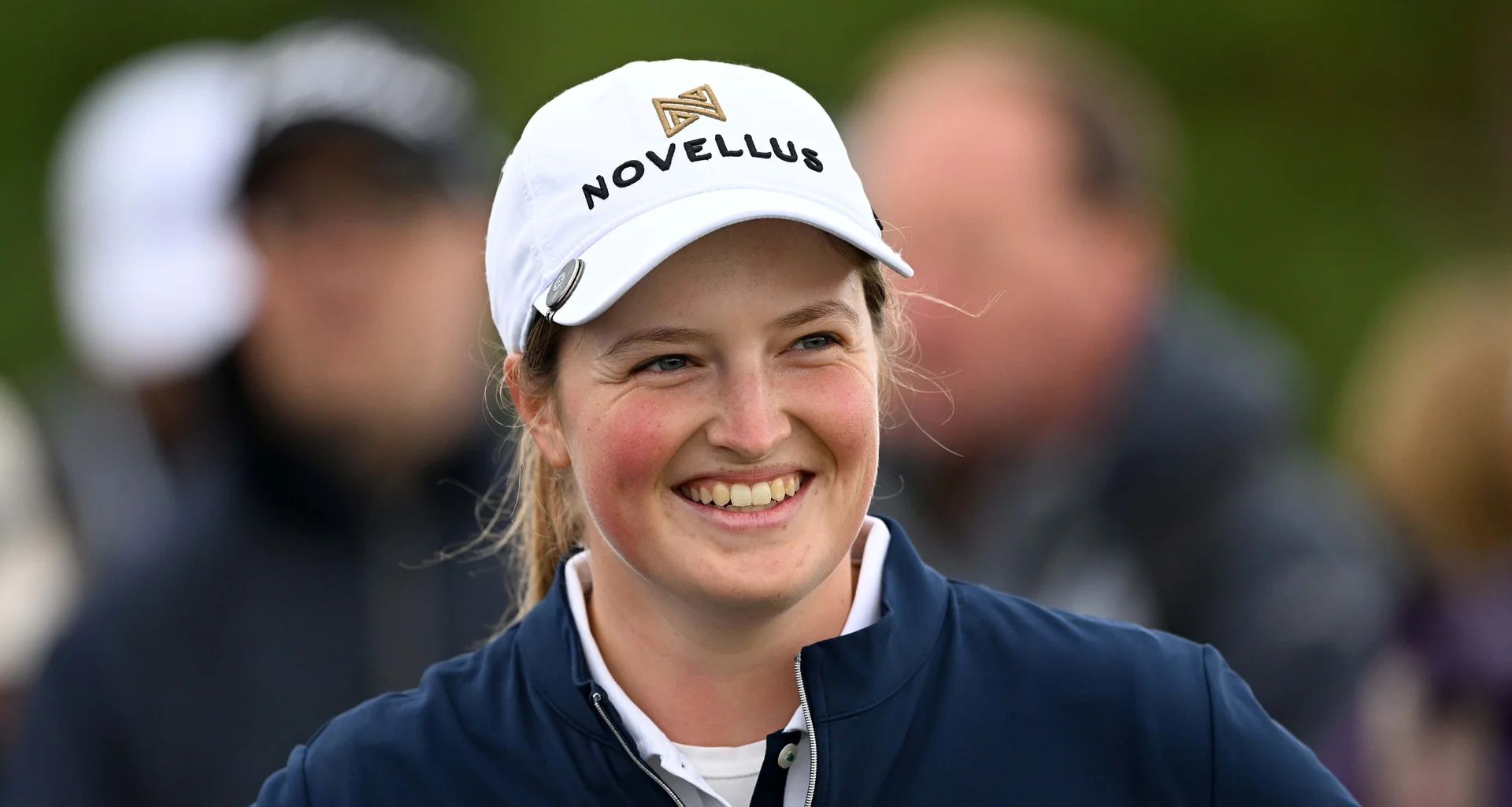 Lottie Woad smiling during a round of golf.