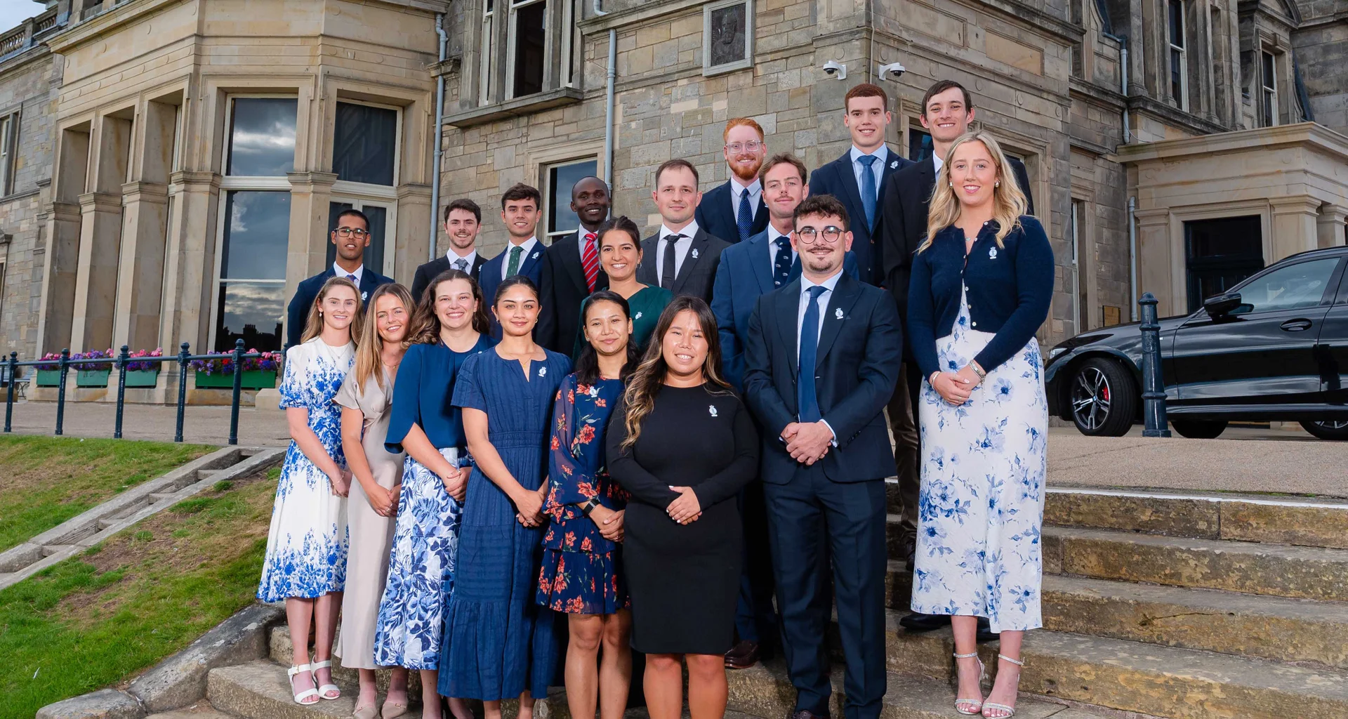 Scholars from the 2025 programme stand on the steps outside The Royal and Ancient Golf Club during the The R&A Scholarship Leadership Conference.