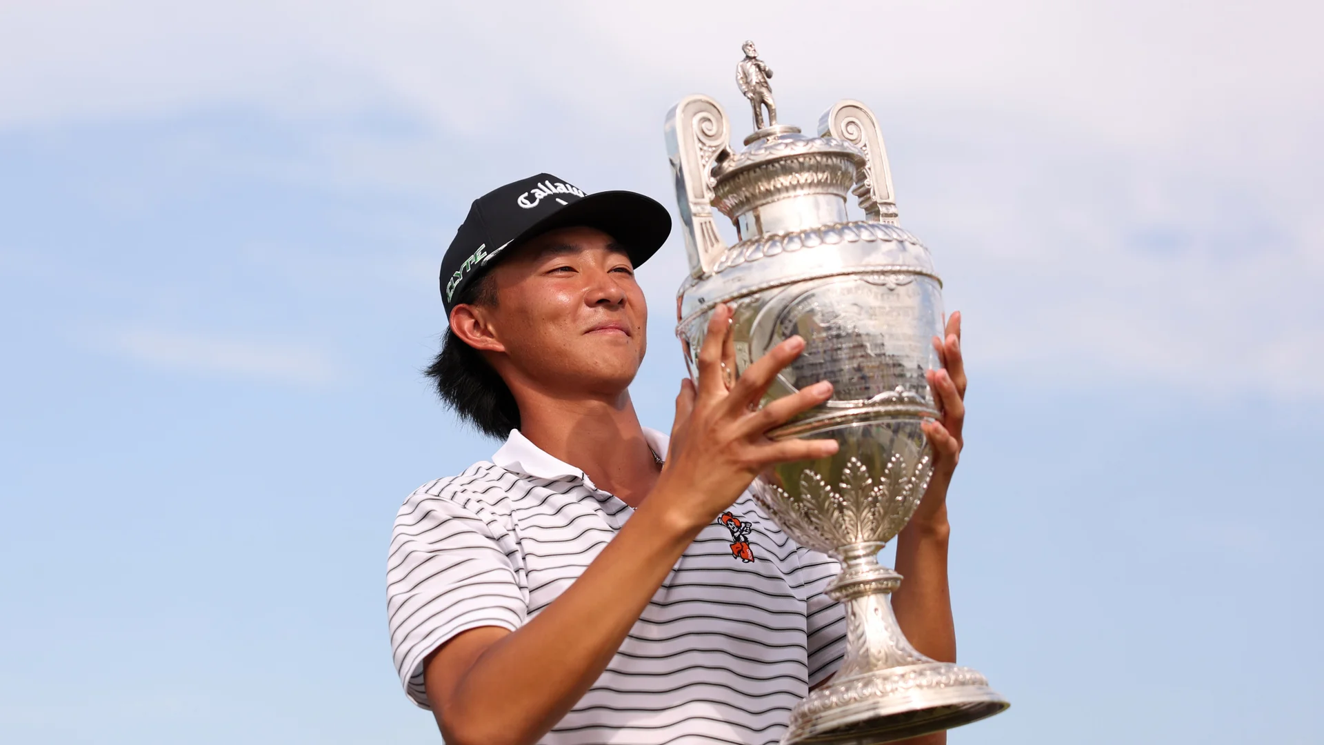 Ethan Fang celebrates with The Amateur Championship trophy after victory at Royal St George's.