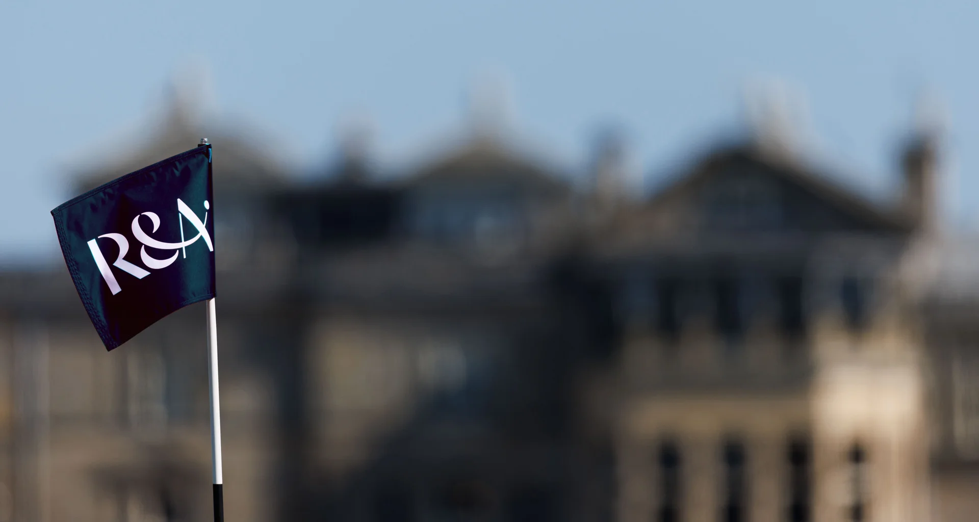 An R&A pin flag in front of the clubhouse at the Old Course, St Andrews.
