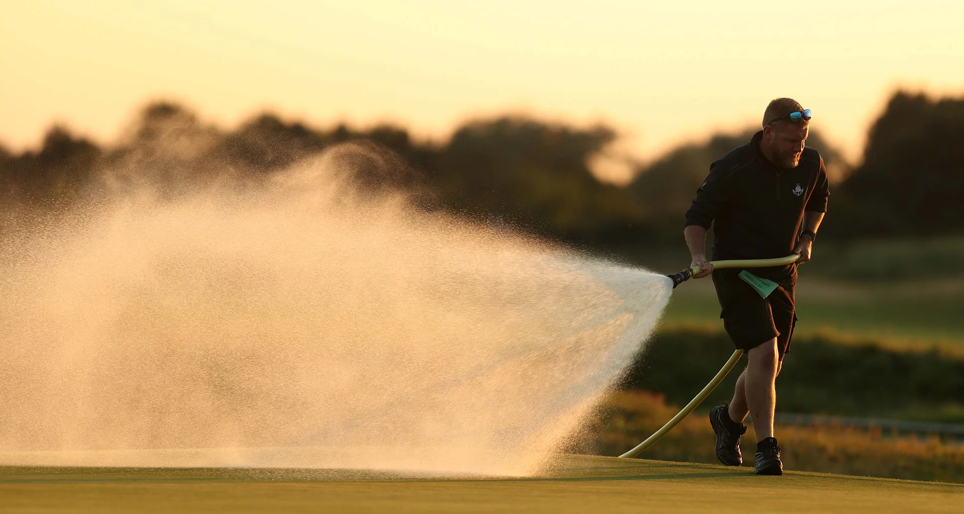 Agronomy work being carried out on a golf course.