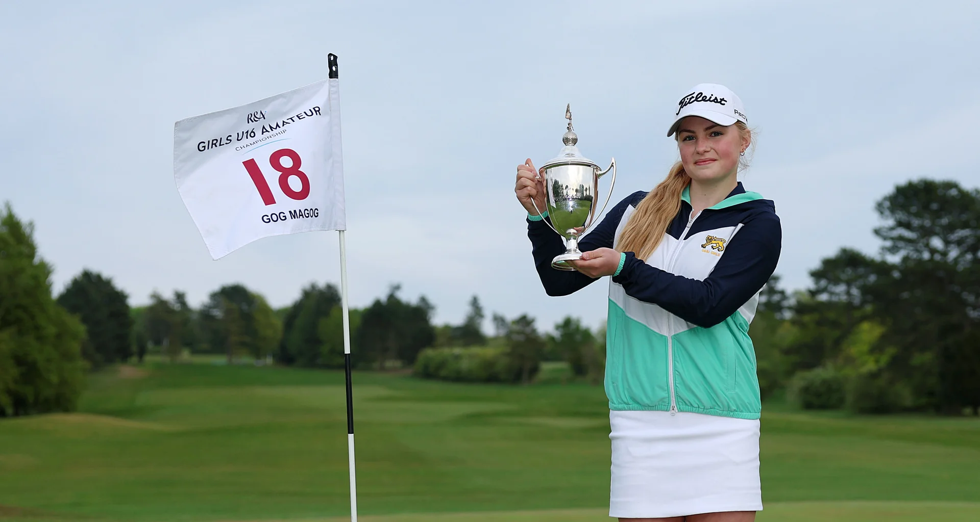 Carly McDonald celebrates with the Girls' U16 Amateur Championship trophy at Gog Magog.