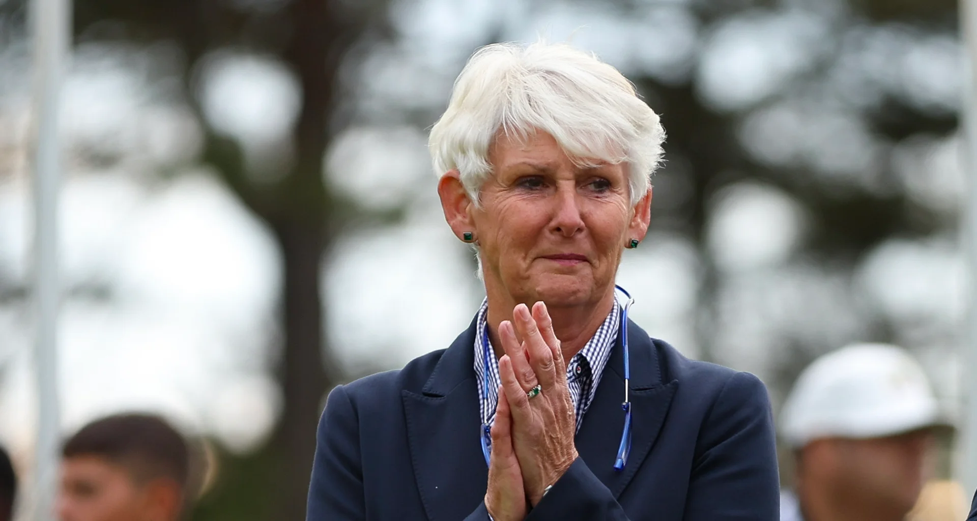 An image of Claire Dowling as she claps her hands together.