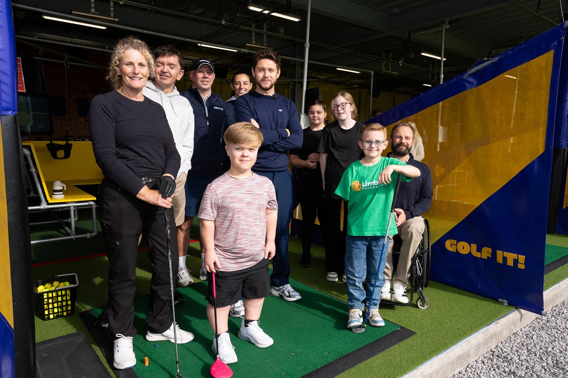 Niall Horan poses for a picture alongside attendees of the Disability Golf Programme at Golf It! in Glasgow.