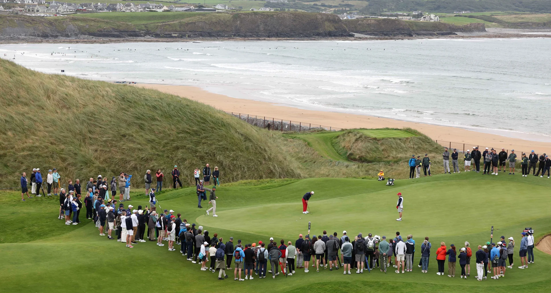 A crowd gather round the 12th green at Lahinch during the 51st Walker Cup.