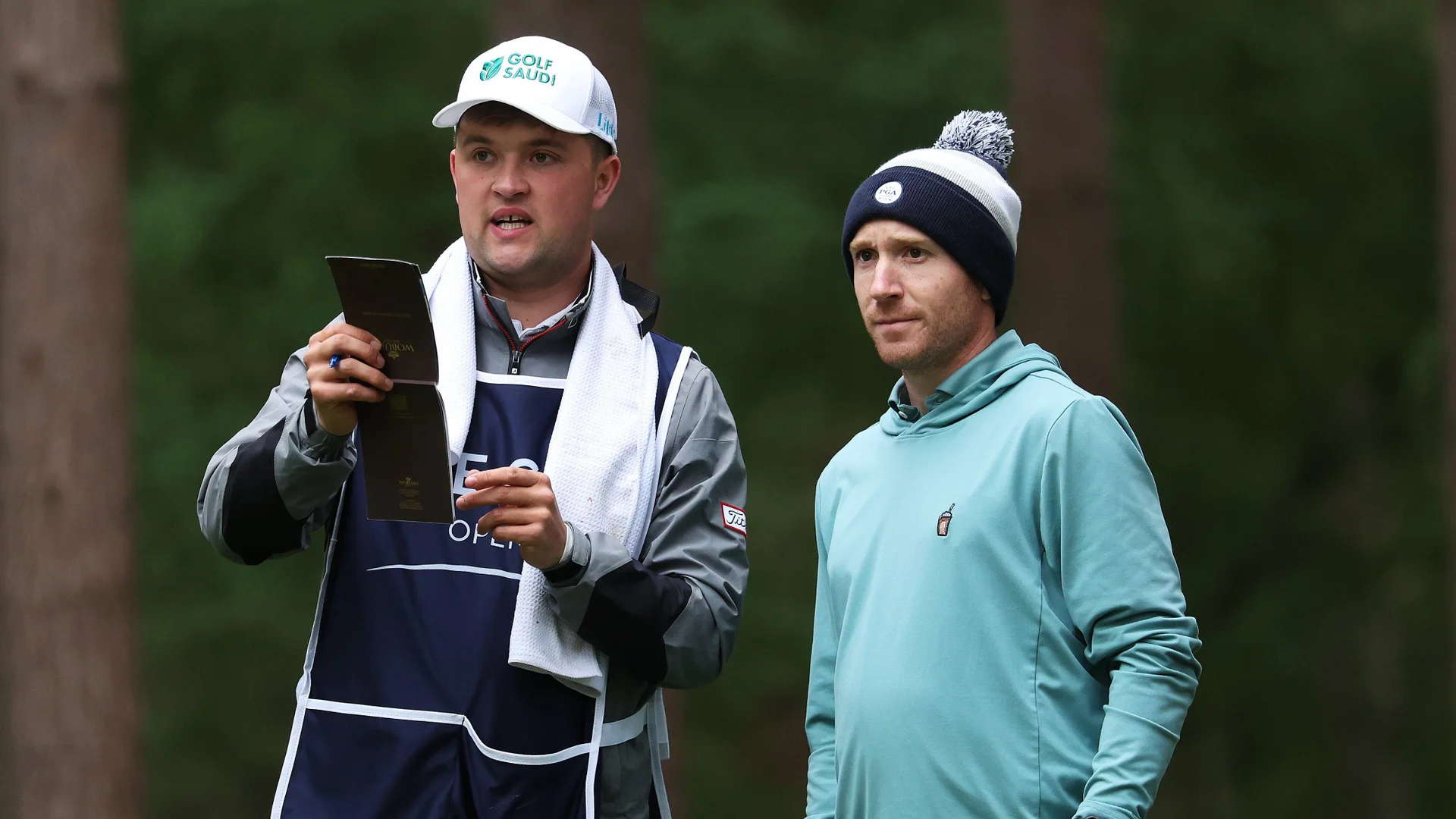 Kipp Popert caddying for Chris Biggins during day one of The G4D Open at Woburn.