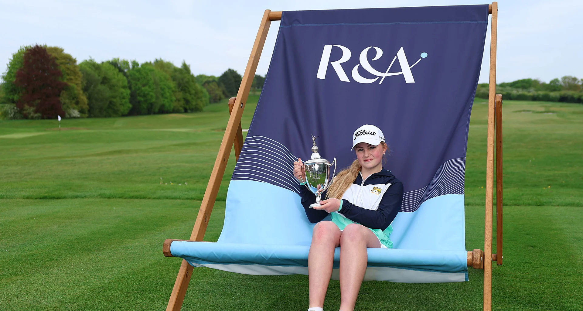 Carly McDonald celebrates with the Girls' U16 Amateur Championship trophy at Gog Magog.