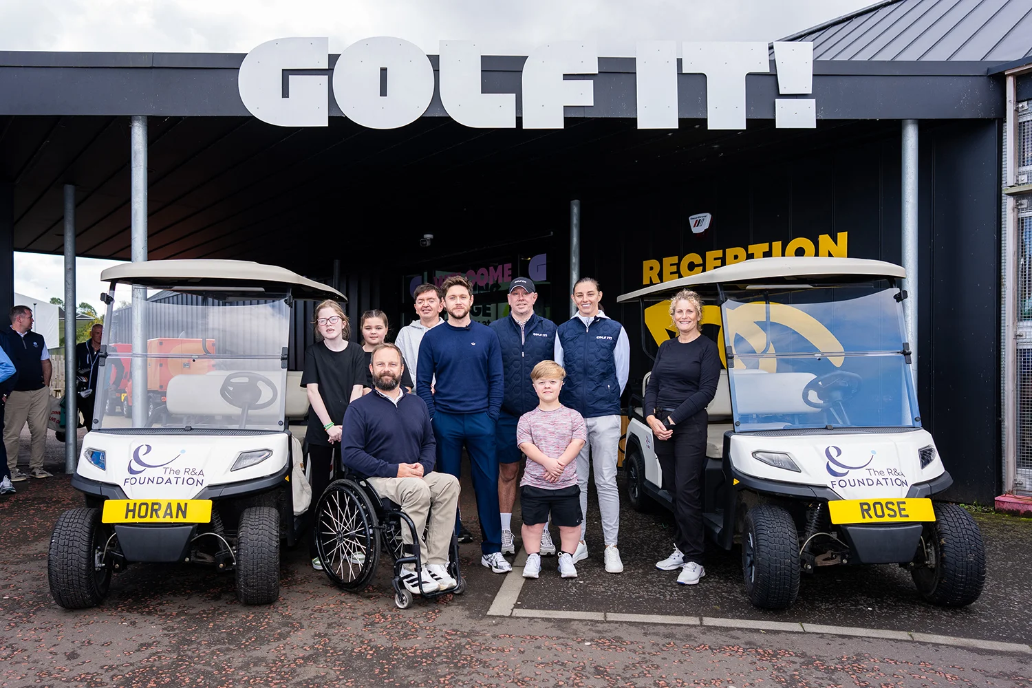 Niall Horan poses for a photograph alongside attendees of the Disability Golf Programme at Golf It! in Glasgow.