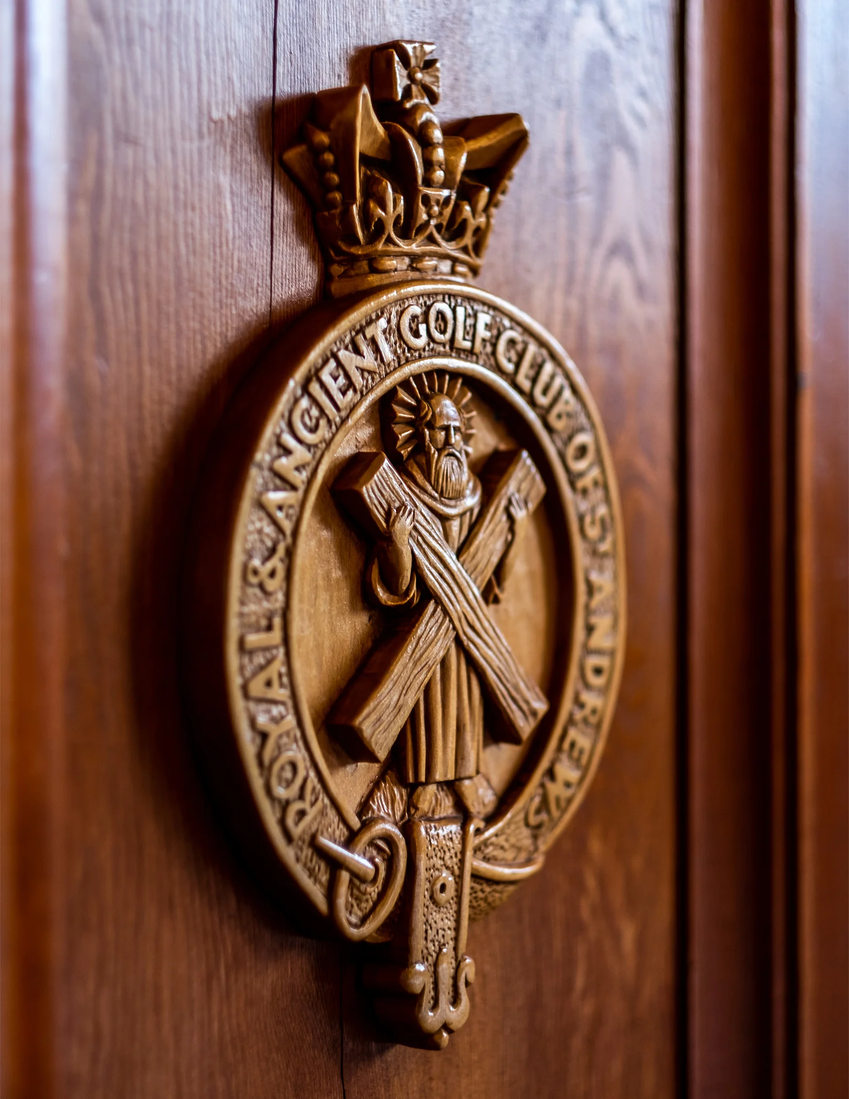 A crest for the Royal and Ancient Club of St Andrews made of wood.