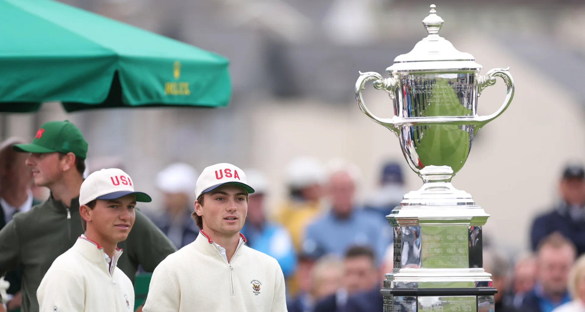 Myles Russell and Tyler Watts look on at the Walker Cup trophy.