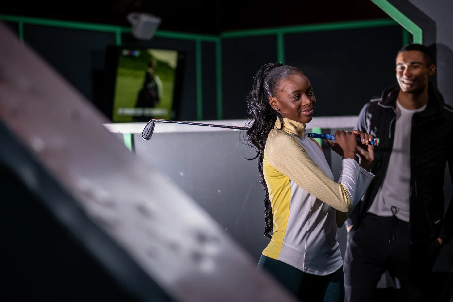Two friends at the golf driving range