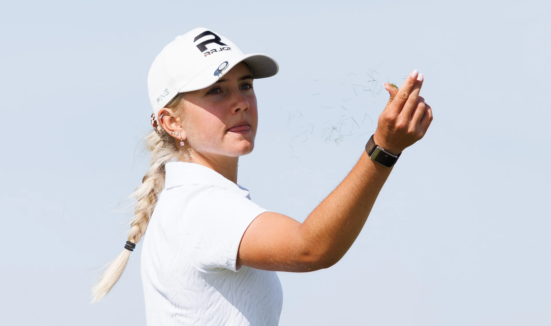 Imogen Hall of England checks the wind direction during Day Two of the R&A Girls' Amateur Championship.