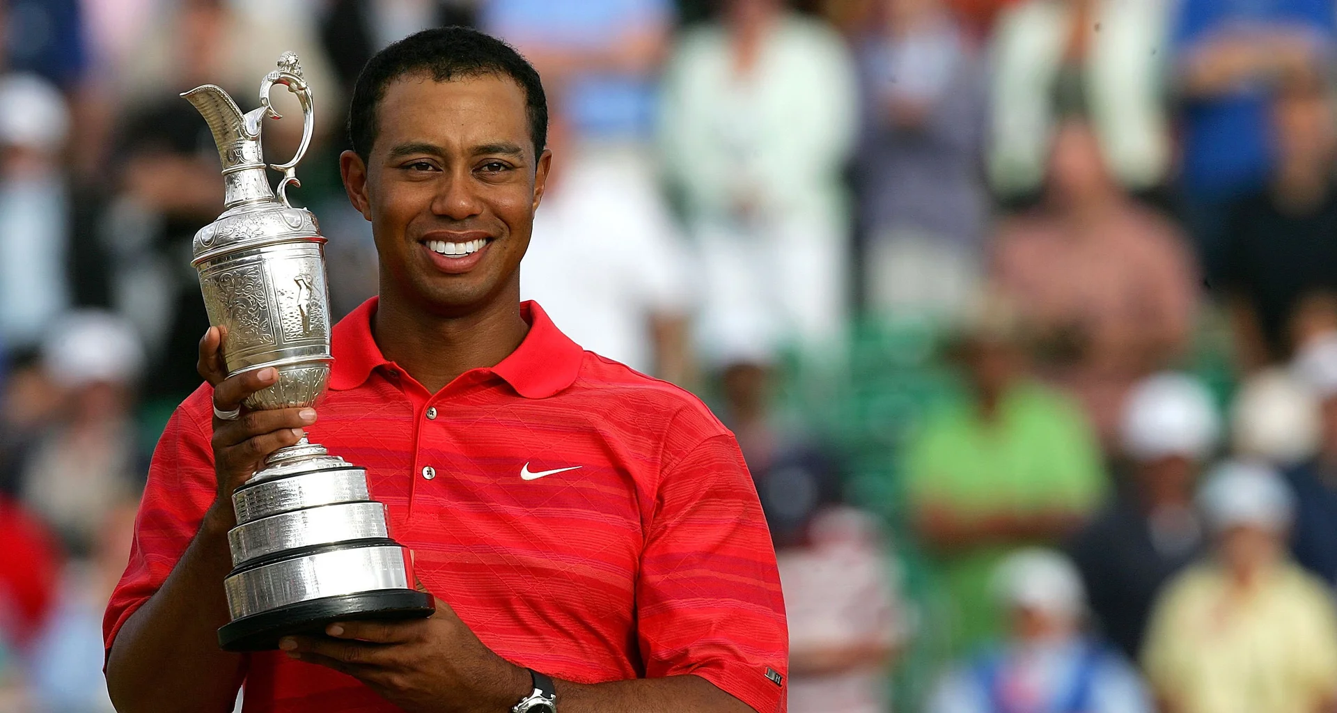 Tiger Woods celebrates with the Claret Jug after winning The Open at Royal Liverpool.