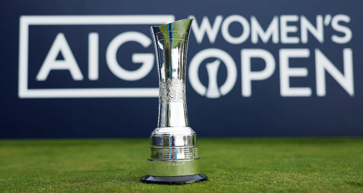 The AIG Women's Open trophy sits on grass in front of a branded Championship sign.