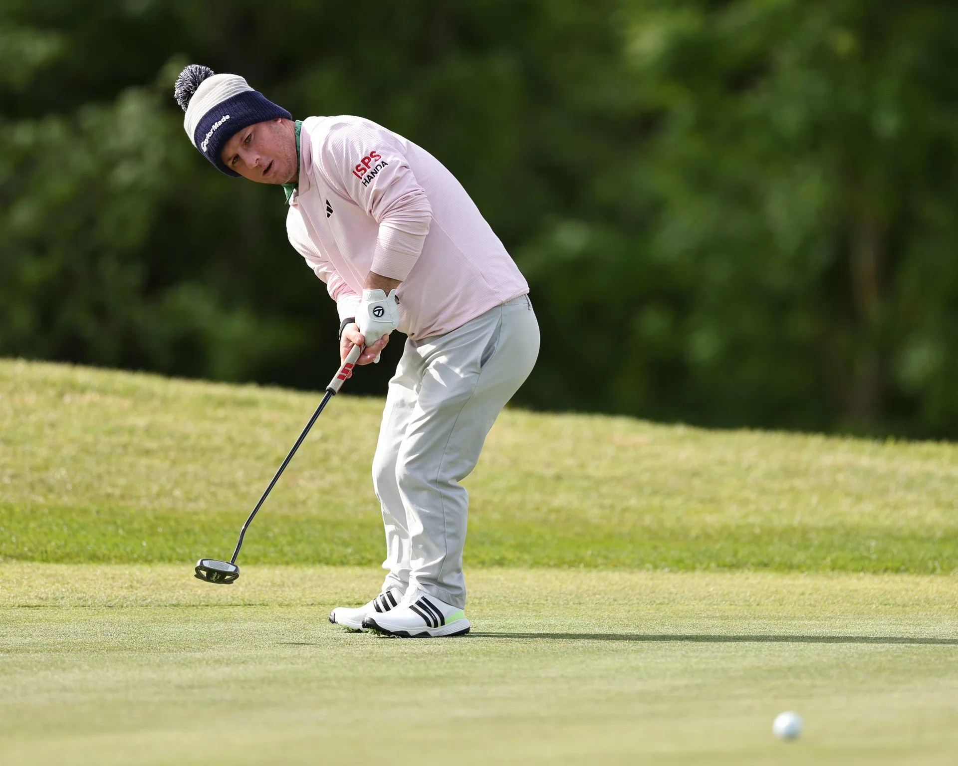 Brendan Lawlor watches on after making a putt.