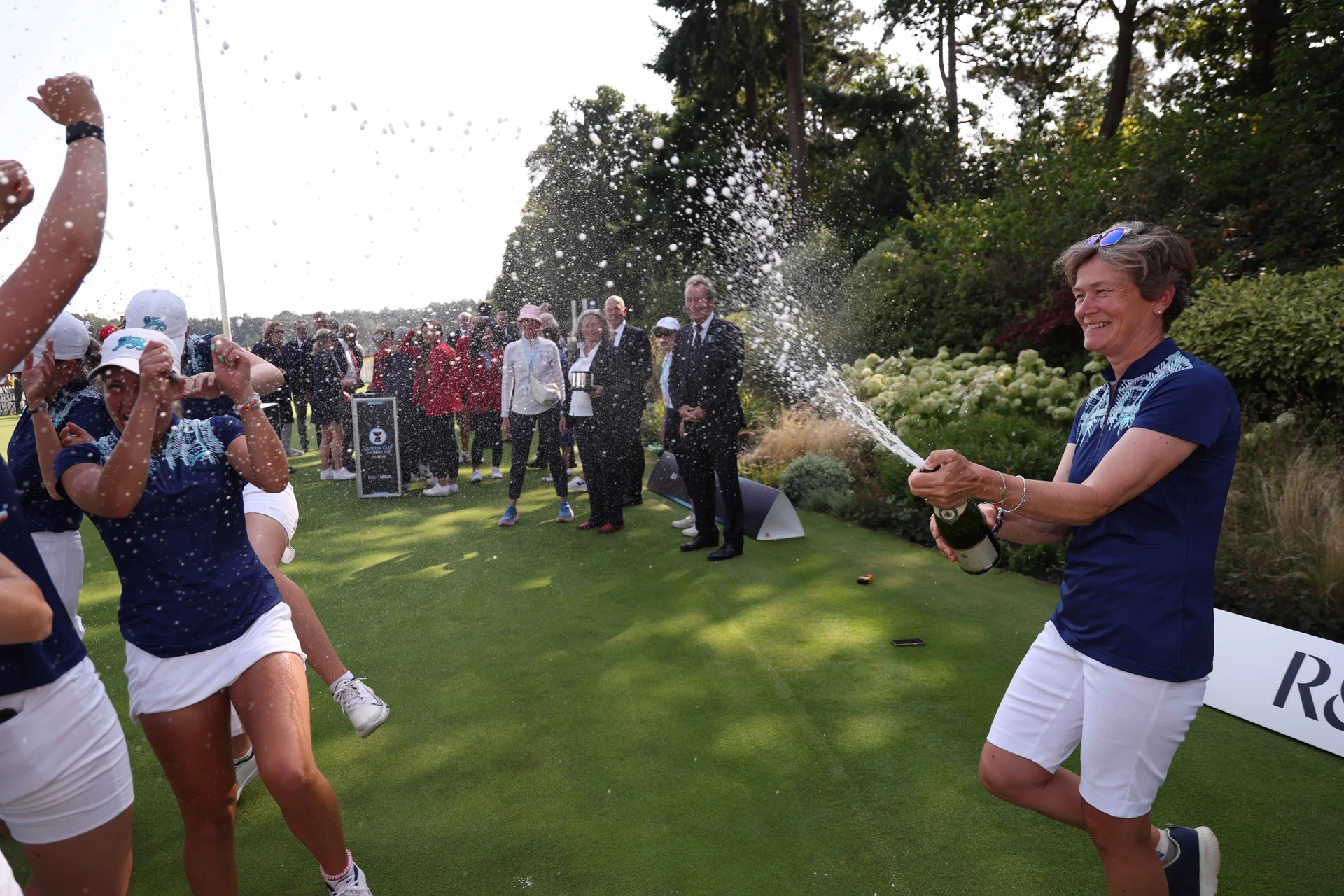 Great Britain & Ireland Captain Catriona Matthew OBE celebrates victory with champagne during the Sunday Singles on Match Day Three of the Curtis Cup at Sunningdale Golf Club