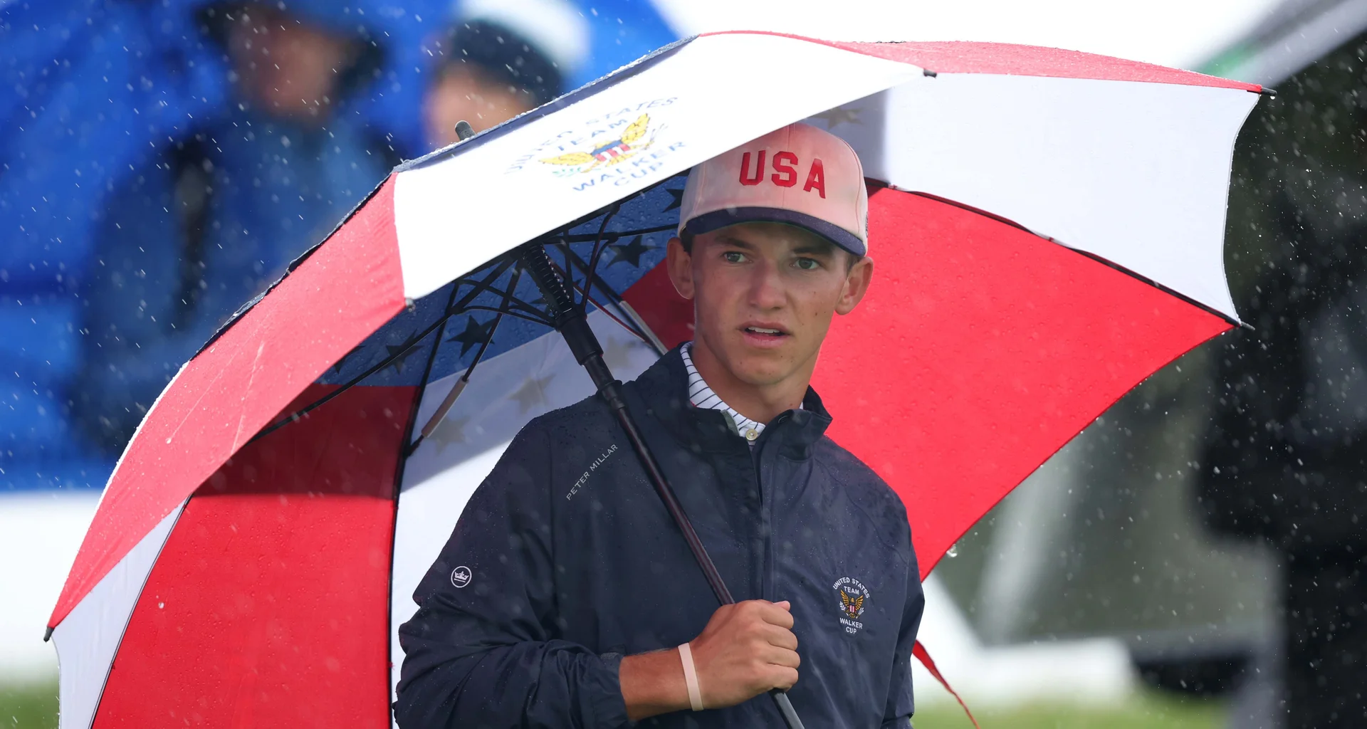 Miles Russell holds an umbrella during day two of the 2026 Walker Cup at Lahinch.