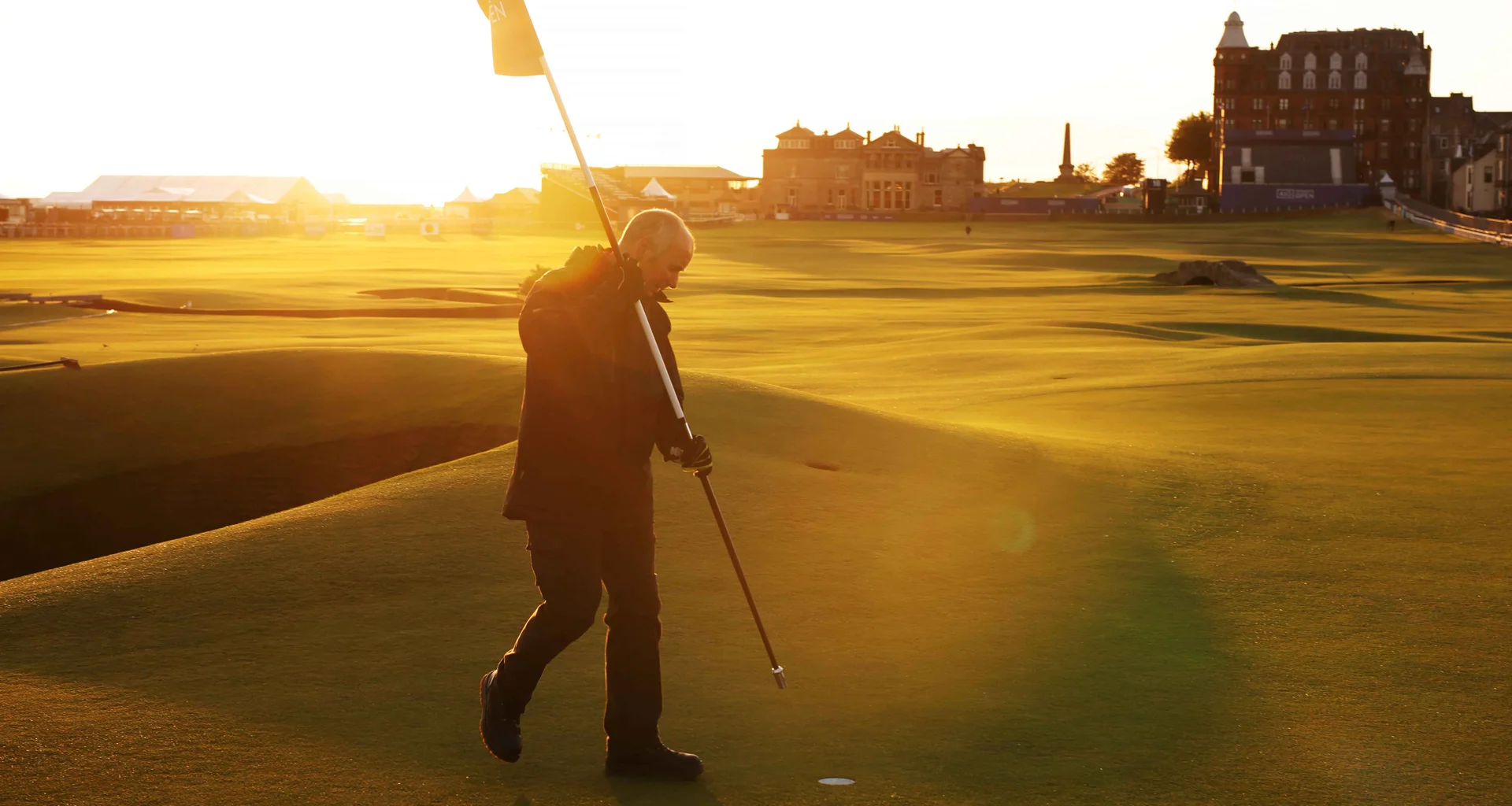 A man places a flagstick in a hole on the St Andrews golf course ahead of the 2024 AIG Women’s Open.
