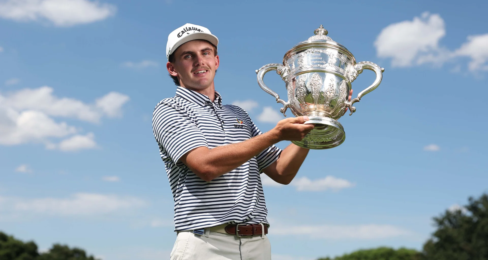 Jack Buchanan holds the Africa Amateur Championship trophy aloft.