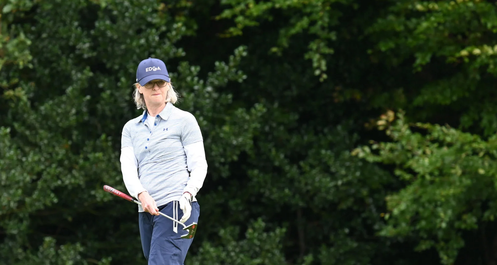 Nicky Weeks eyes up a putt with her putter in hand.