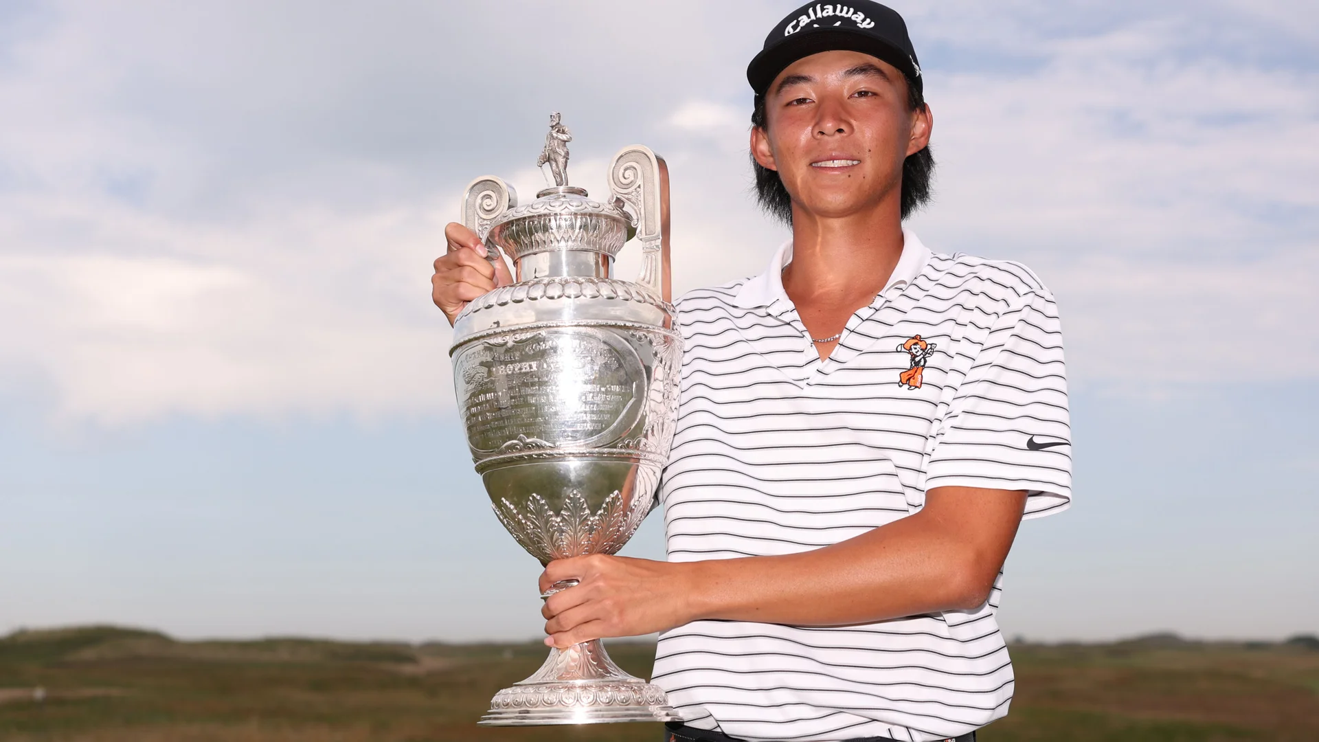 Ethan Fang with the Amateur Championship trophy after victory at Royal St George's.