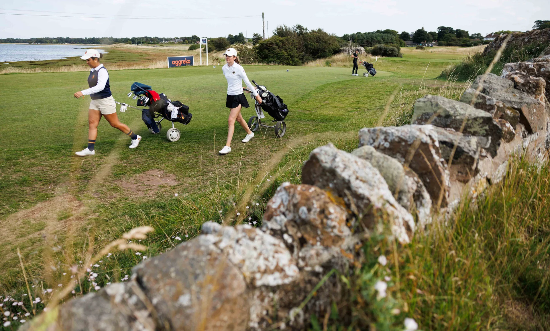Chanya Huaysan of Spain (L) and Laetitia Leisinger of Germany walk off the 6th tee during Day Two of the R&A Girls' Amateur Championship.