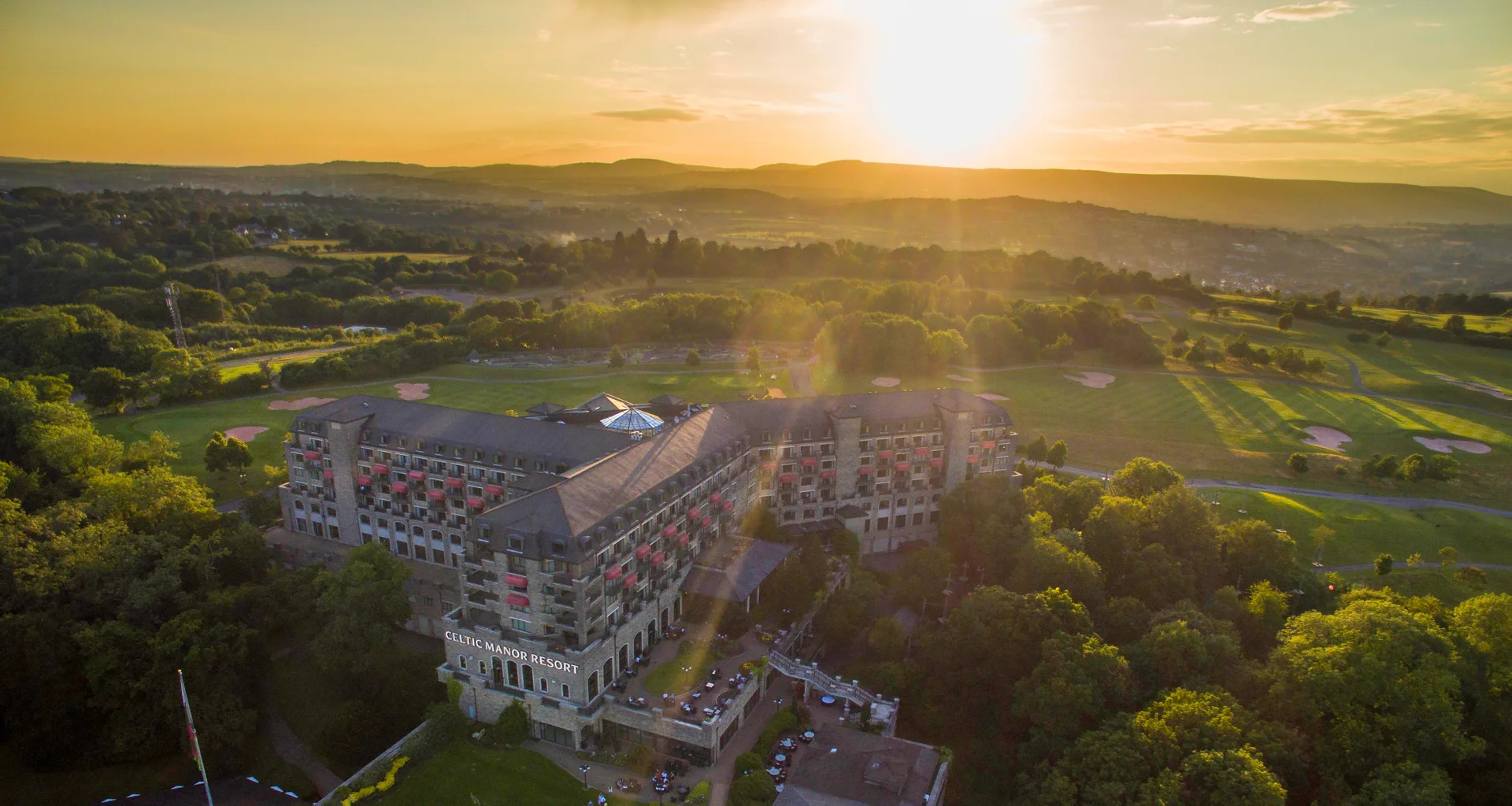 An aerial view of the Celtic Manor Resort Hotel at sunrise.