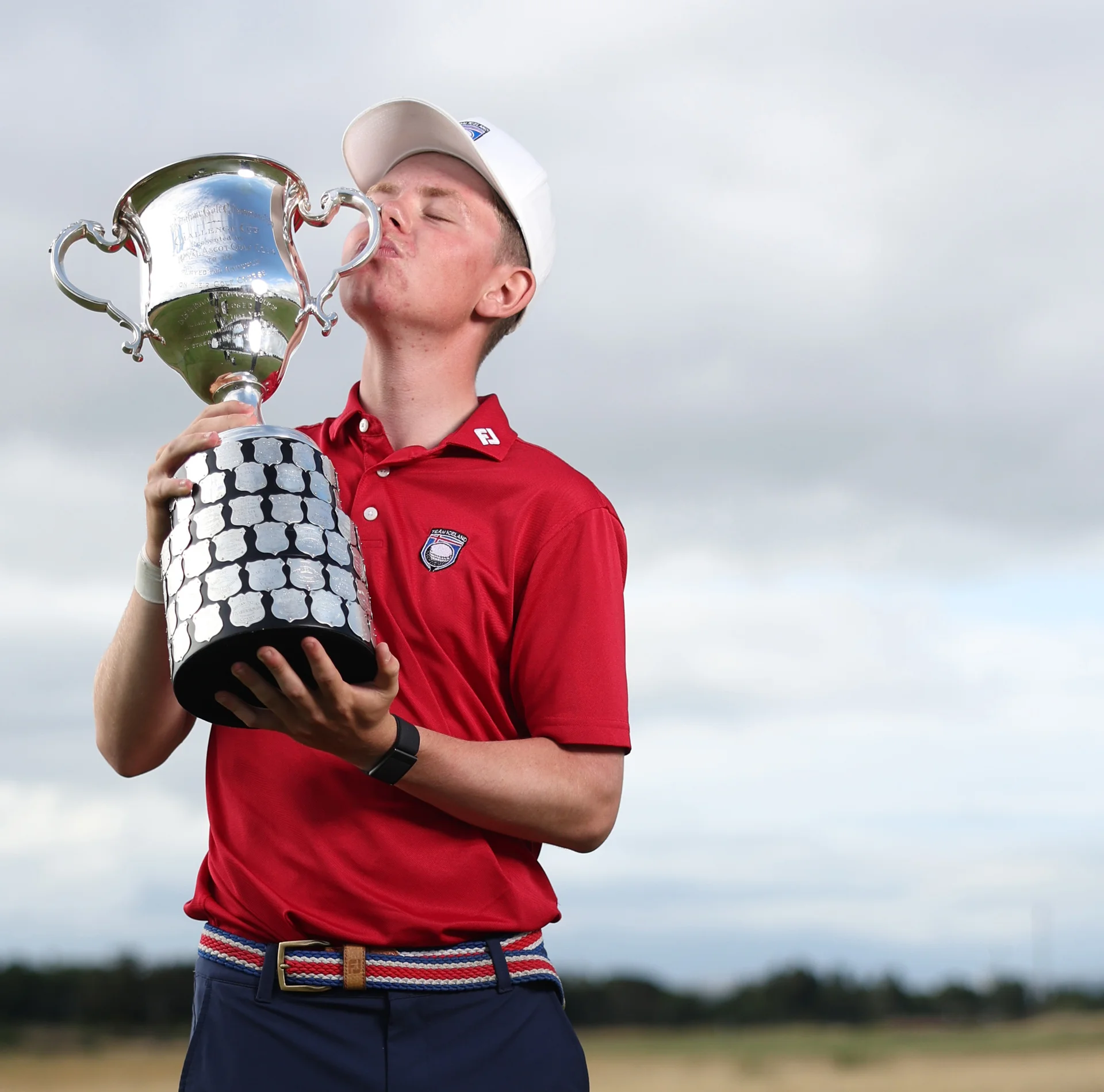 Oliver Eli Bjornsson celebrates with the Boys' Amateur Championship trophy.
