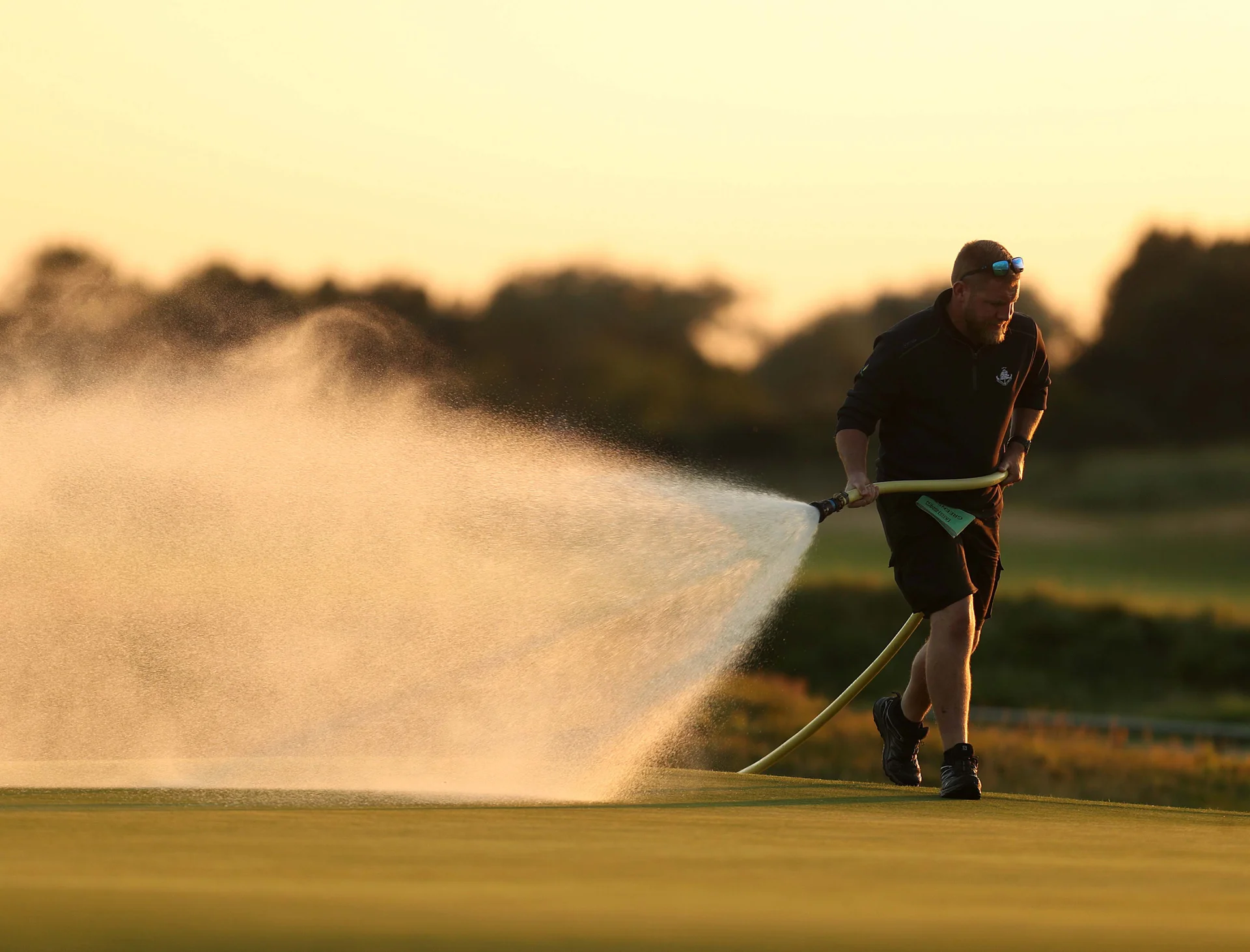 Agronomy work being carried out on a golf course.
