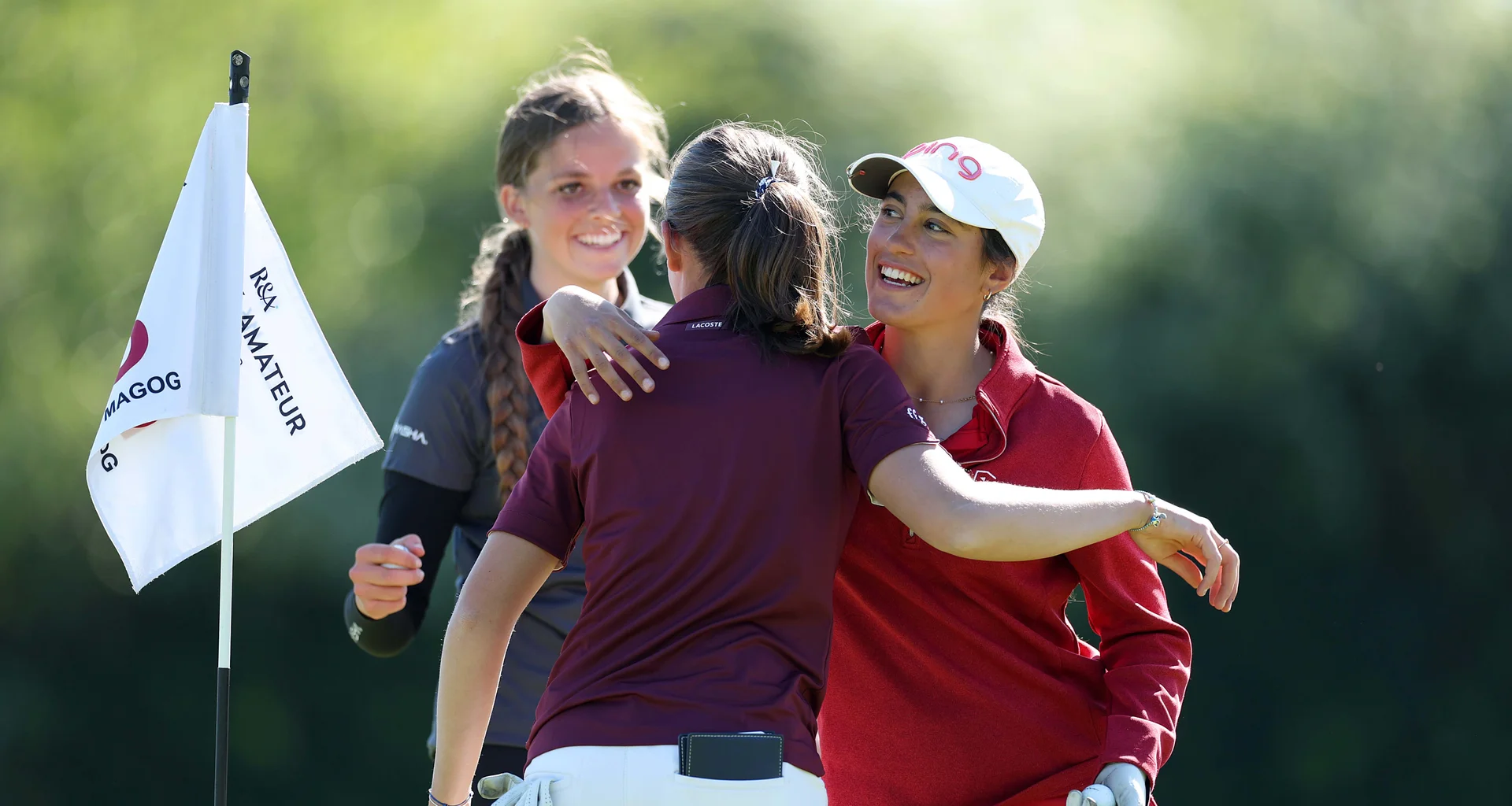 Rebecca Del Sol-Gonzalez of Pennard embraces playing partner Ludvine Passe of France on the 18th green following their round during Day One of the R&A Girls U16 Amateur Championship at Gog Magog Golf Club.