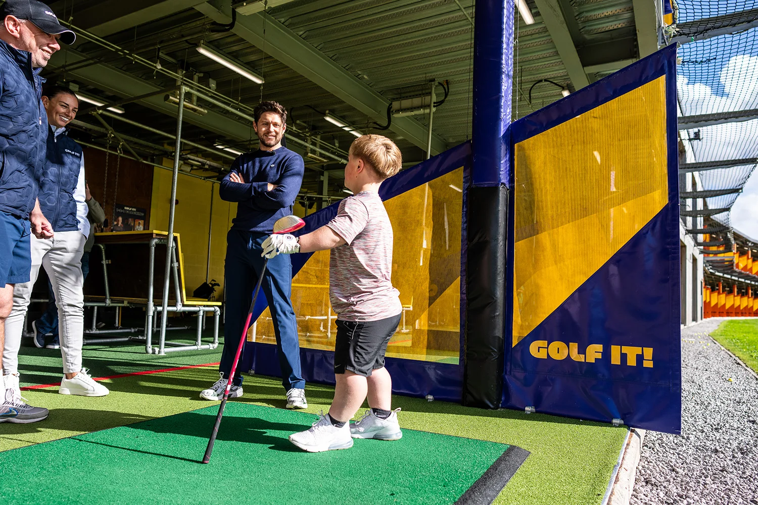 Niall Horan chats to an attendee of the Disability Golf Programme at Golf It! in Glasgow.