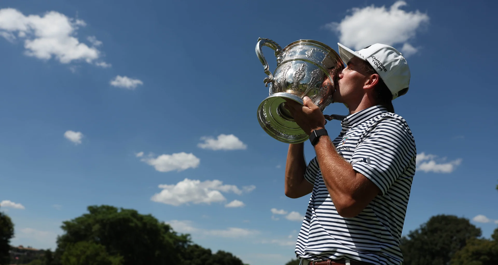 Jack Buchanan of South Africa kisses the trophy following his victory during Day Four of the Africa Amateur Championship at Royal Johannesburg.