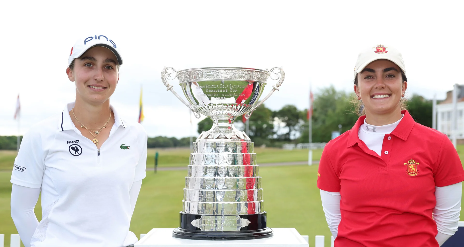 Valentine Delon of France (L) & Andrea Revuelta of Spain pose with the trophy by the 1st tee during the Final of the 2026 Women's Amateur Championship at Muirfield.