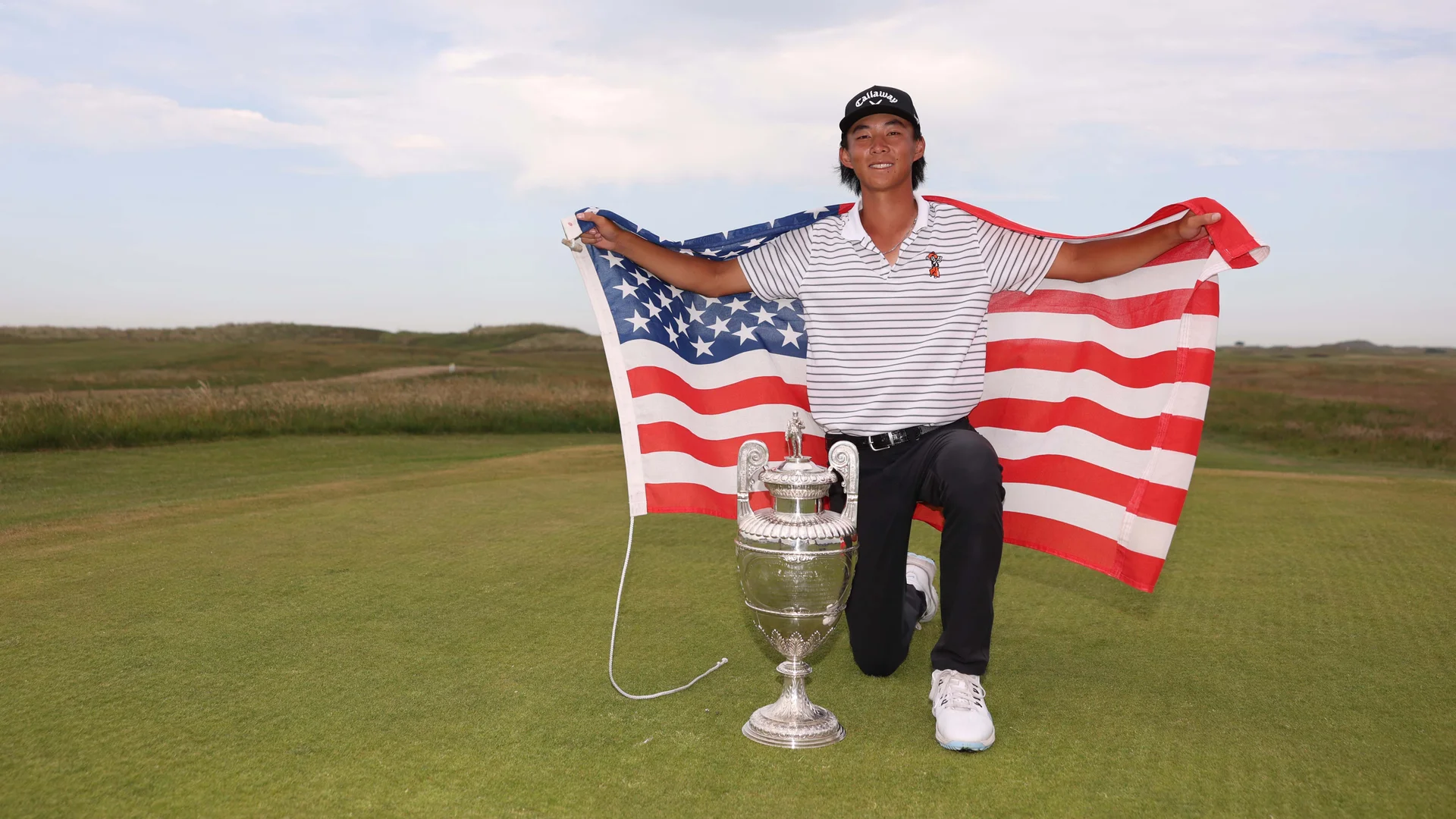 Ethan Fang celebrates with The Amateur Championship trophy.