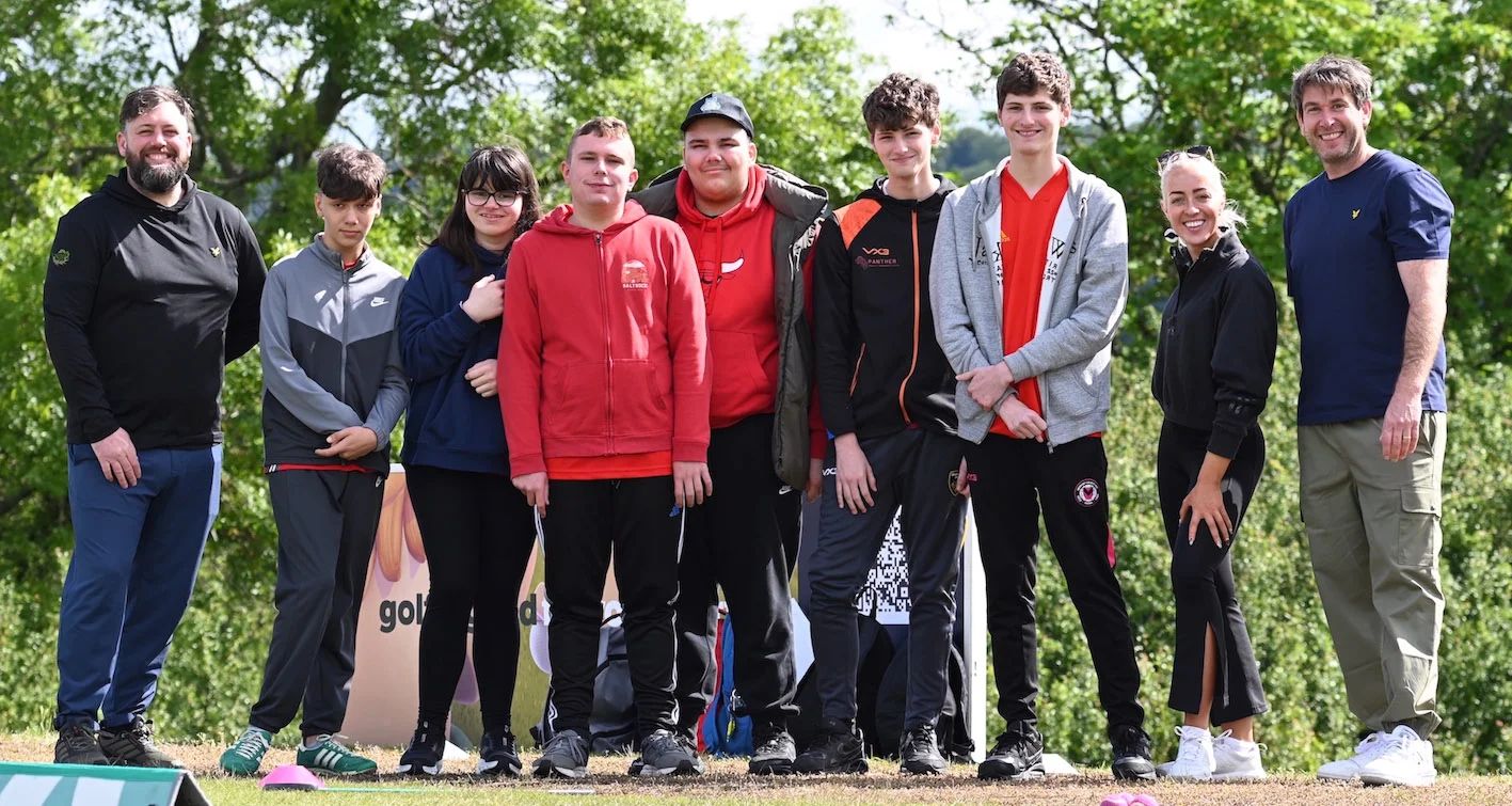 A group of people stand together after taking part in a golf session at The G4D Open.