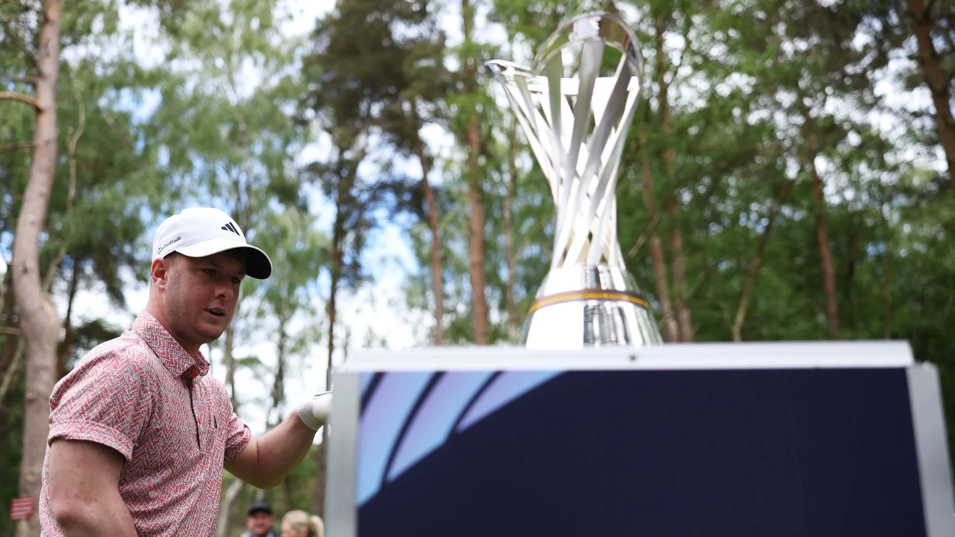 Brendan Lawlor walks past The G4D Open trophy on day three of the event at Woburn. 17 May, 2025.