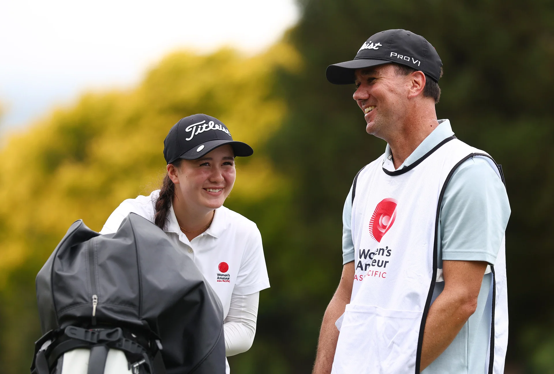 Elise Barber of New Zealand reacts with her father and caddie on day two of the The Women's Amateur Asia-Pacific Championship at Royal Wellington Golf Club on February 13,