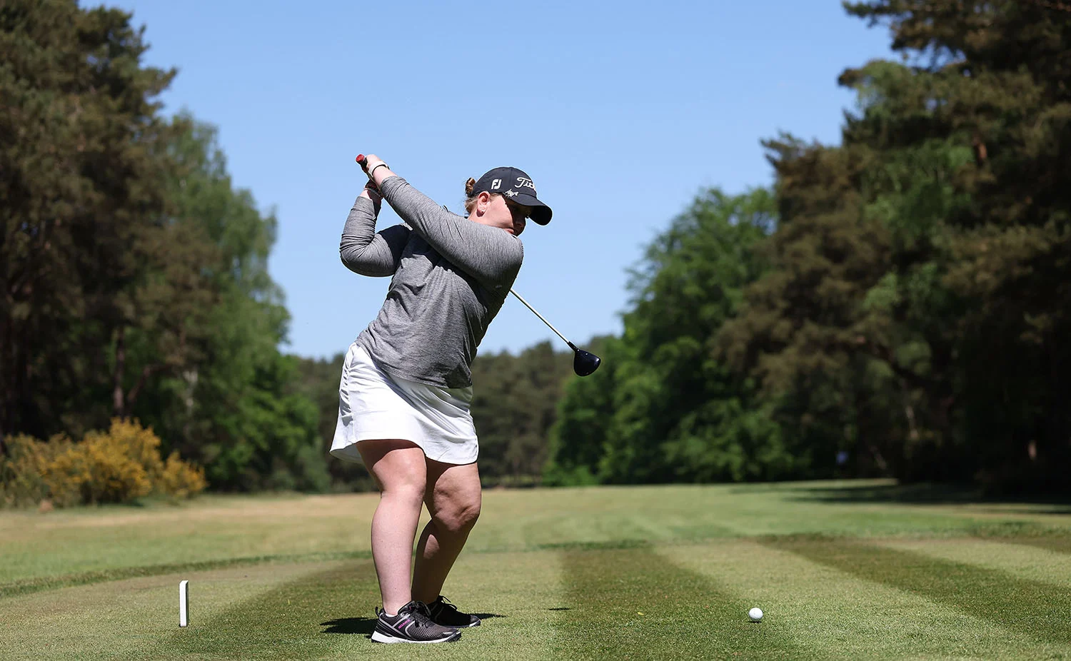 Natasha Stasiuk tees off at The G4D Open at Woburn in 2025.