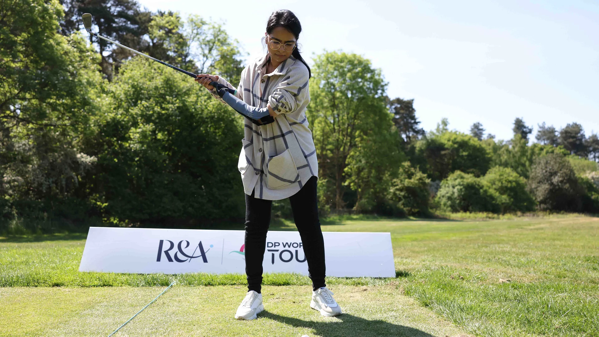 Anitha Rahulan uses an innovative new device, designed to improve access to golf for those with arthritis, on the practice range at Woburn.