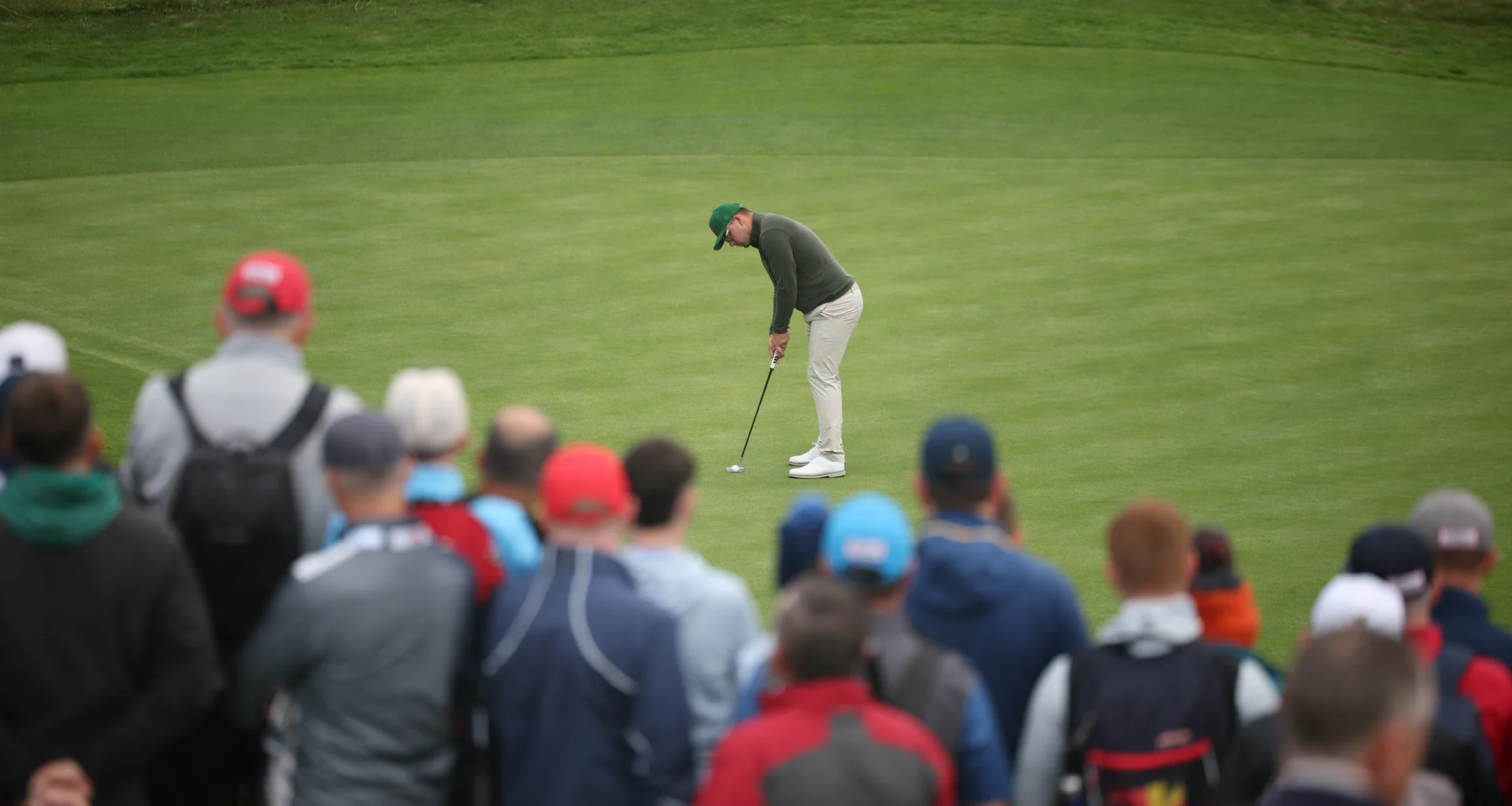 A large crowd watches on as Eliot Baker makes a putt at the 51st Walker Cup at Lahinch.
