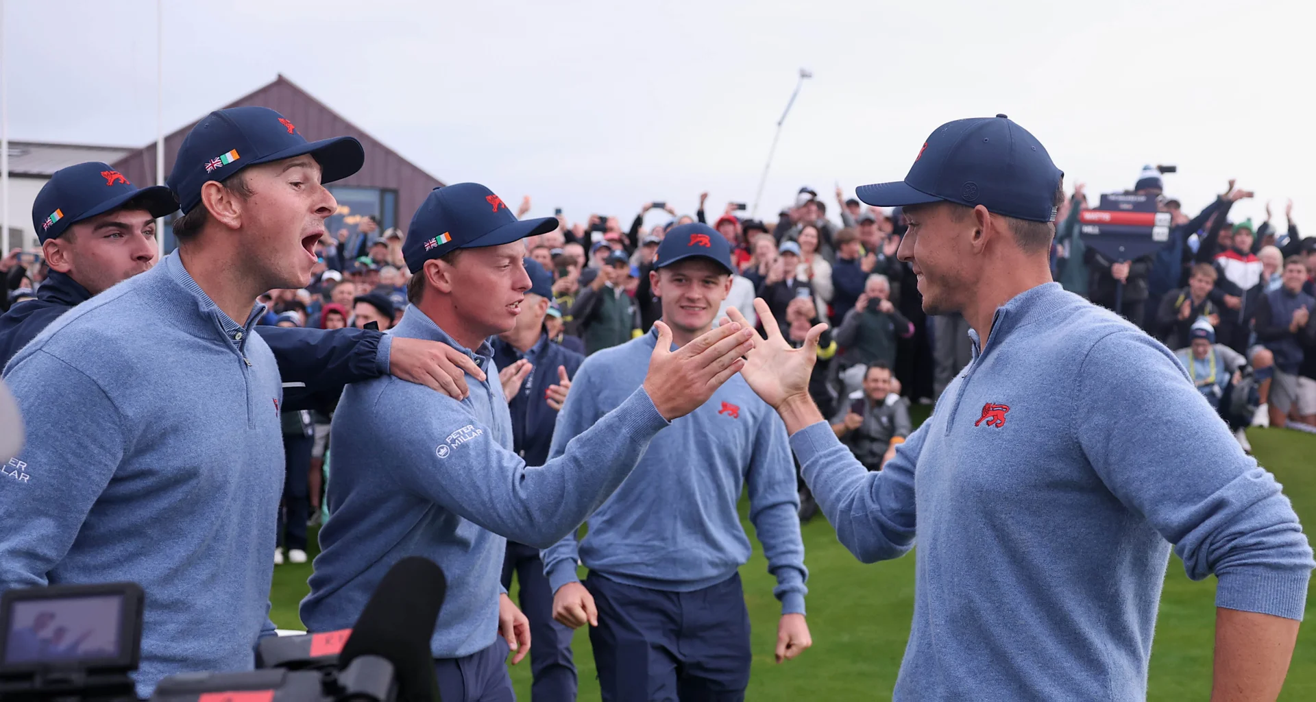 Josh Hill of Team GB&I celebrates with teammates following victory of the walker cup.