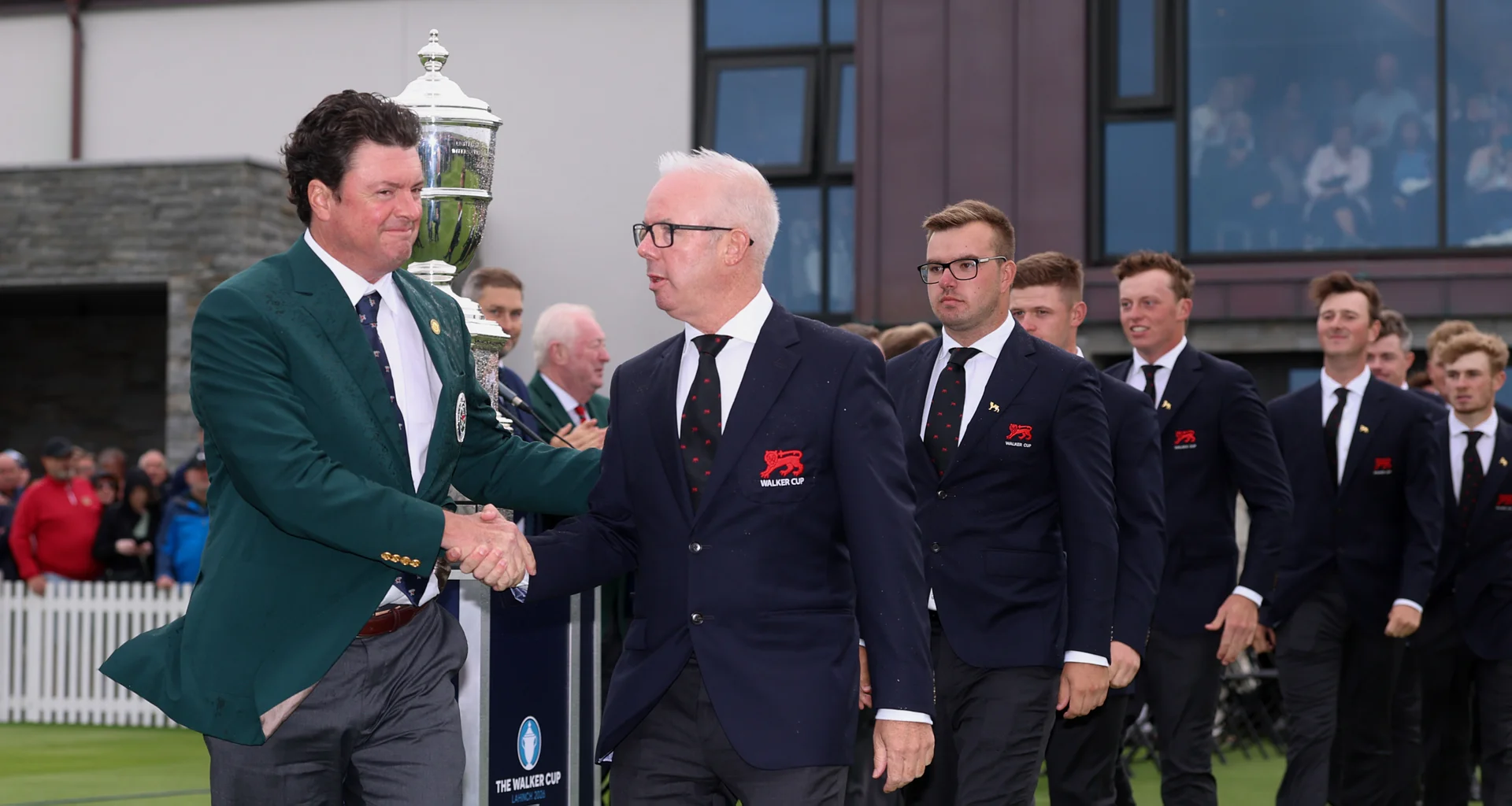 Nathan Smith and Dean Robertson shake hands at the opening ceremony of the 2026 Walker Cup at Lahinch.