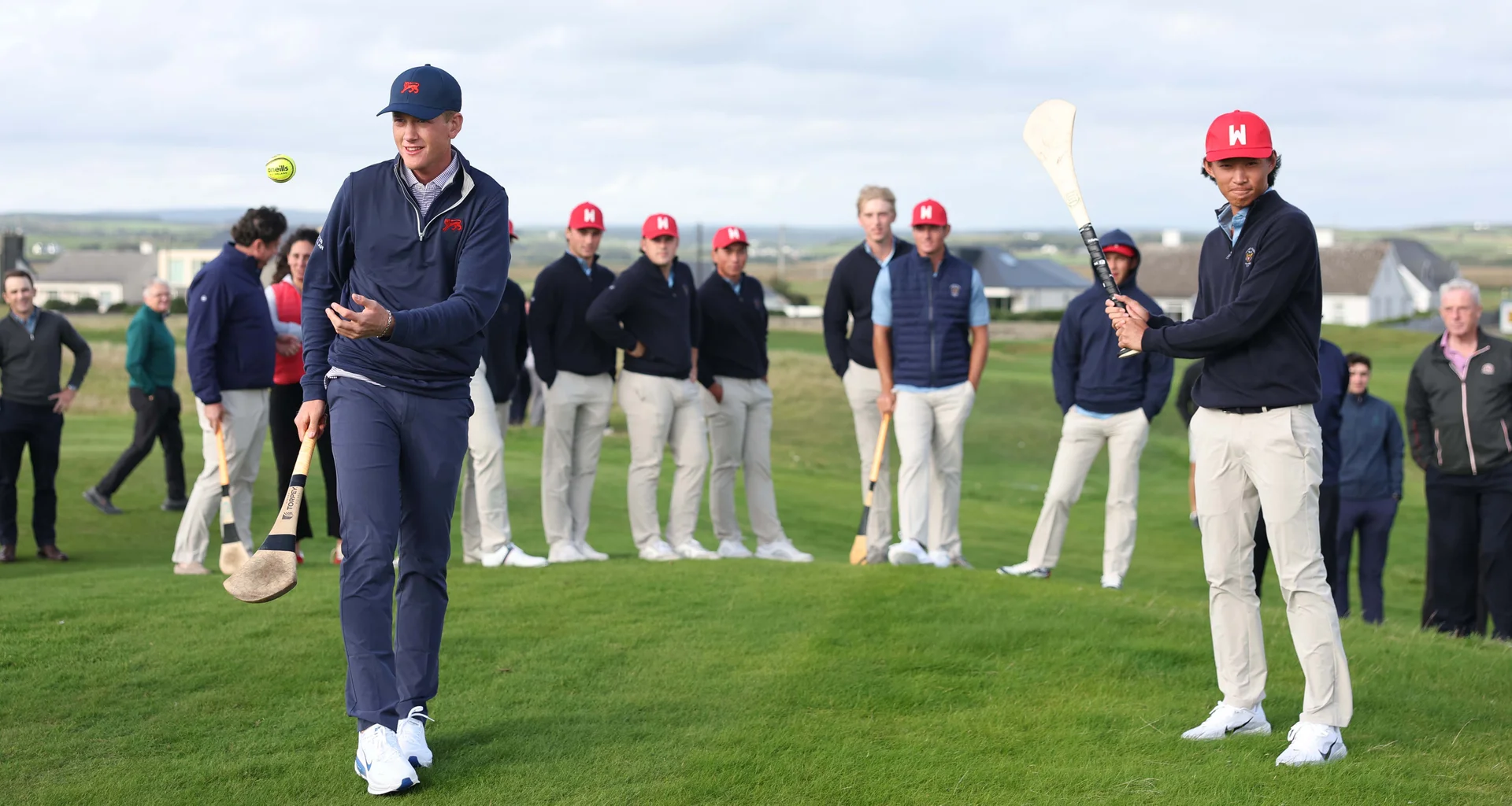Luke Poulter of Great Britain and Ireland and Ethan Fang of the USA take part in a hurling activity ahead of the 2026 Walker Cup at Lahinch.