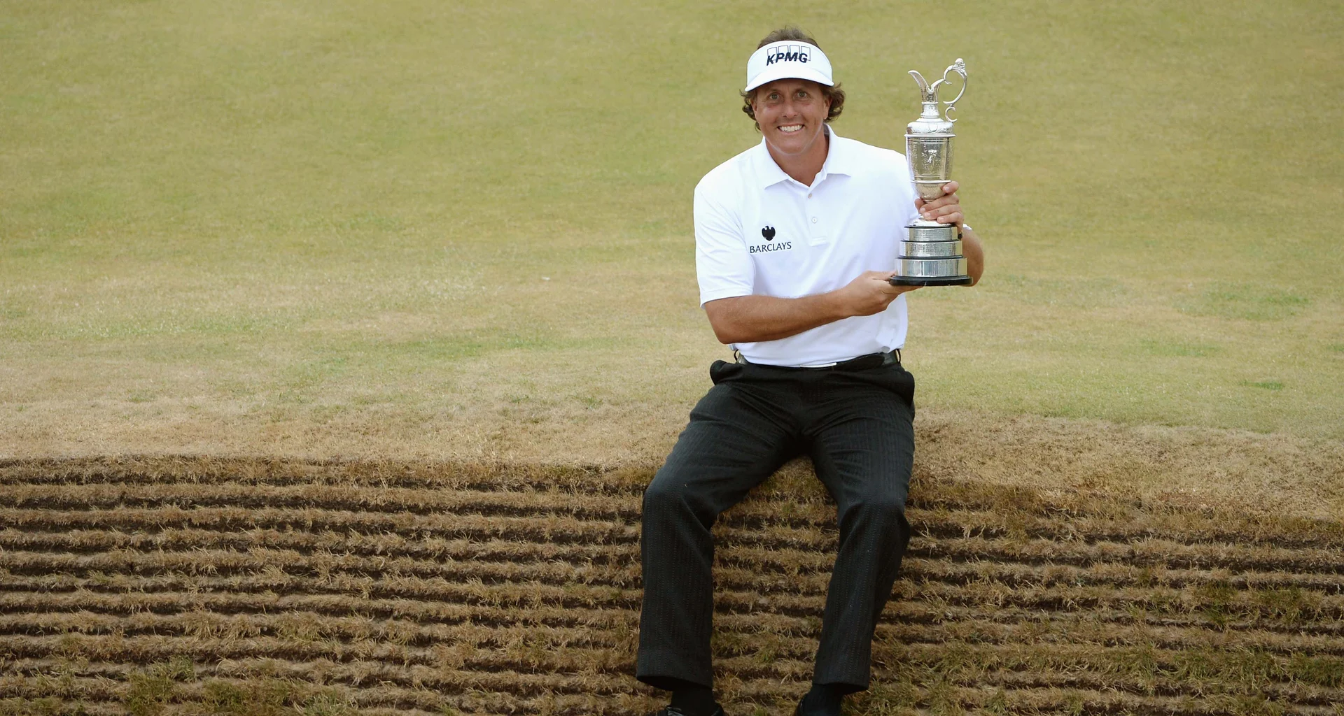 Phil Mickelson celebrates with the Claret Jug after winning The Open at Muirfield.
