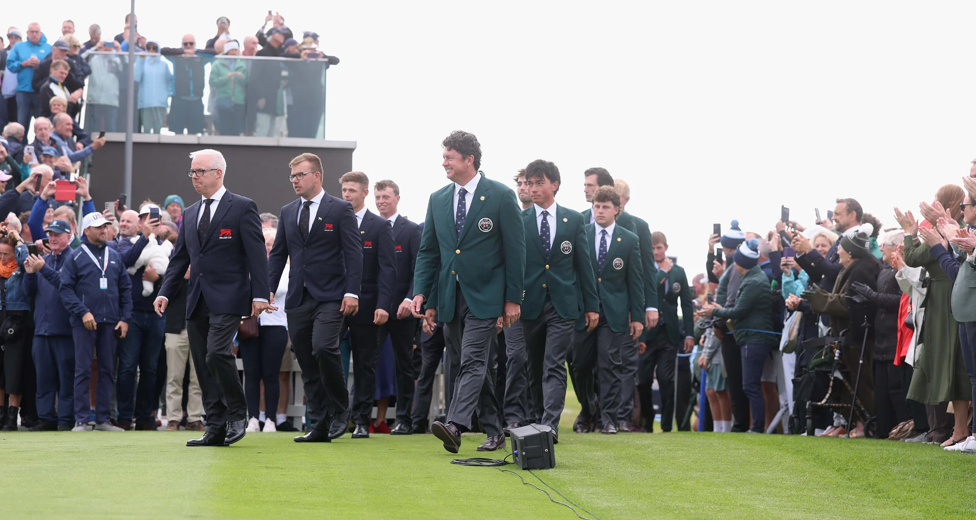 Dean Robertson of GB&I and USA Captain Nathan Smith lead their teams out for the opening ceremony of the 51st Walker Cup.