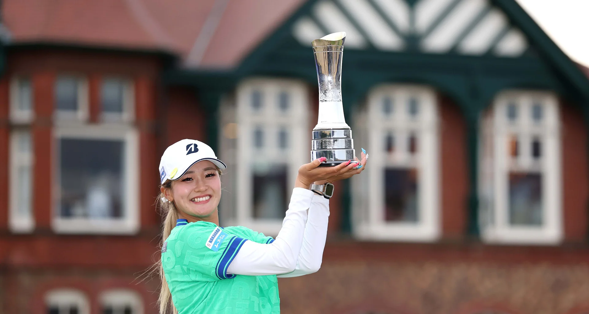 Shiho Kuwaki celebrates with the AIG Women's Open trophy after her victory at Royal Lytham & St Annes.