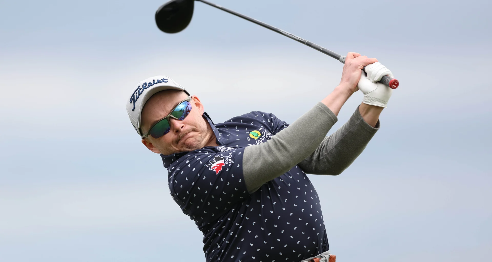 Kurtis Barkley of Canada plays a tee shot.