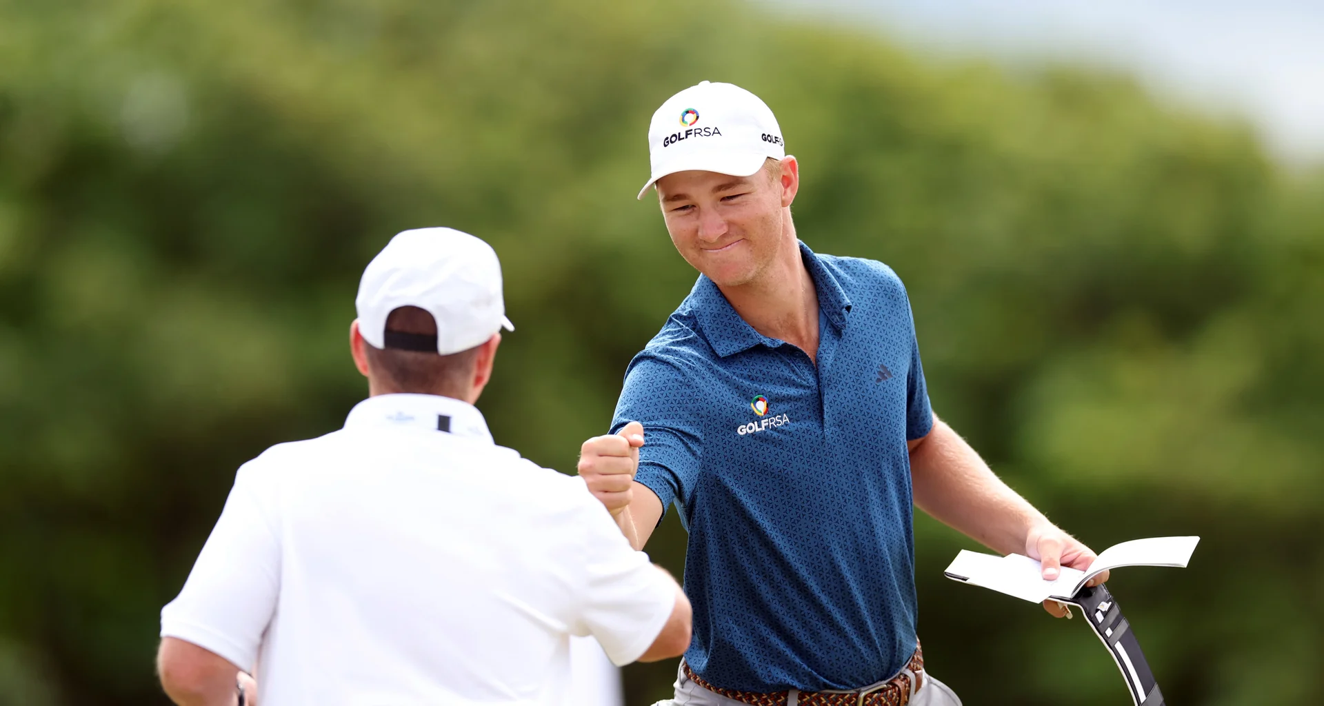 Malan Potgieter fist bumps during the second match play round of The 131st Amateur Championship at Royal Liverpool.