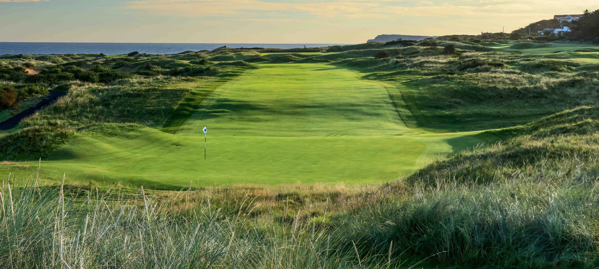 A golf course green and fairway.
