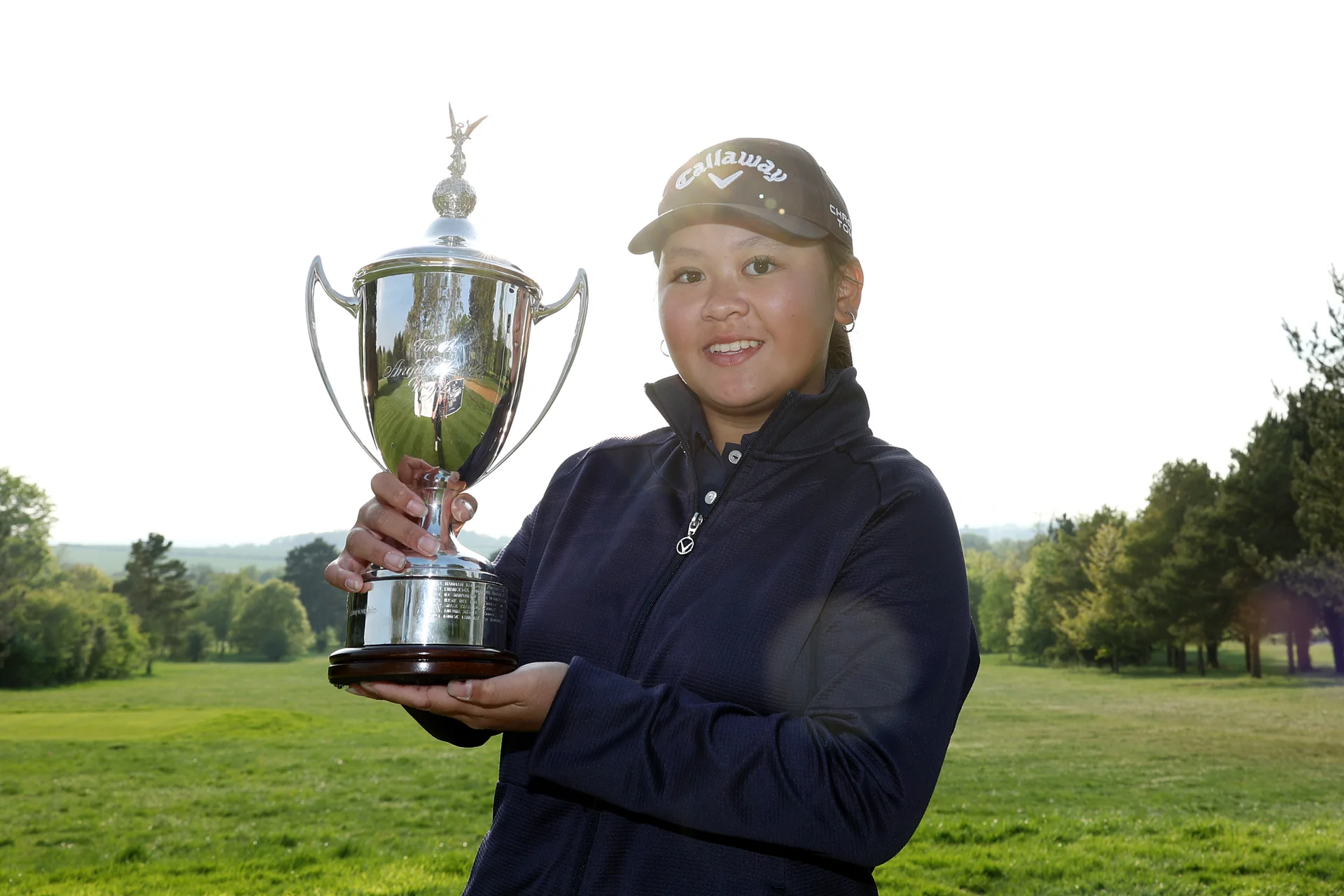 Sabrina Wong lifts the Girls' U16 Amateur trophy at Gog Magog